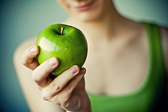 Green Granny Smith apple with girl